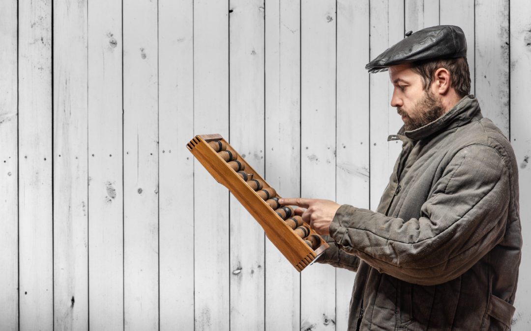 Man sorting out finances on abacus after receiving VAT return advice