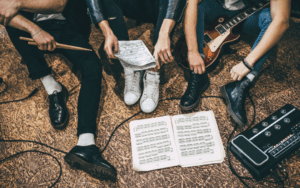 Band sat together writing music