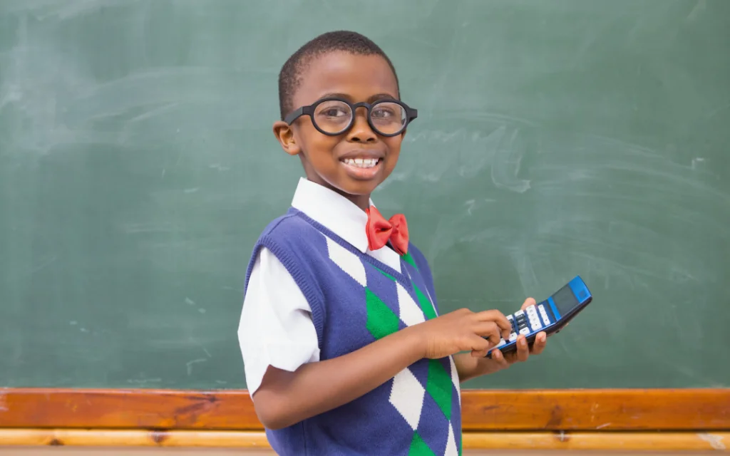 Kid using calculator to action our accounting tips for startups