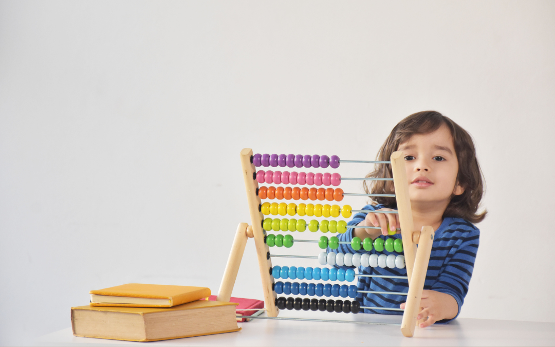 Young child using an abacus to instil our SME business finance tips
