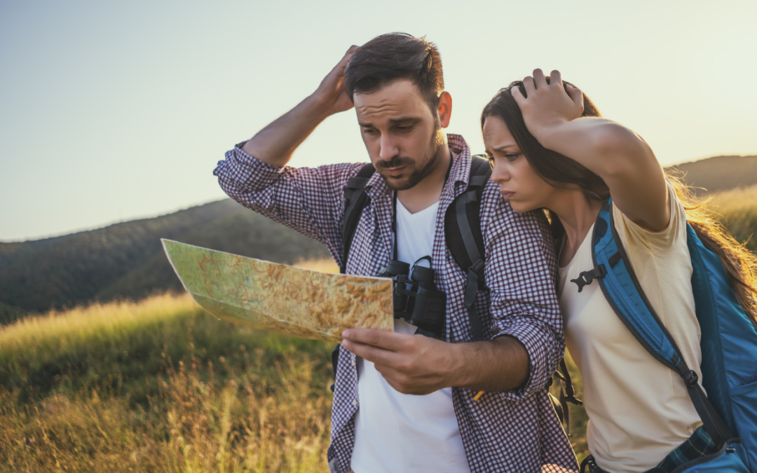 A man and women lost looking at a guide.