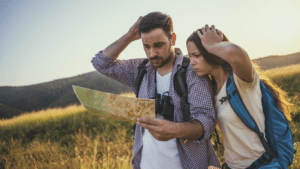 A man and women lost looking at a guide.