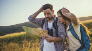 A man and women lost looking at a guide.