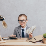 A kid dressed up as an accoutant, sat at a desk, about to explain why budgeting is so important.