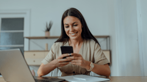 A women smiling after growing her accounting business with the help of a business coach.
