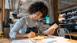 A business owner smiling after reading our small business bookkeeping tps